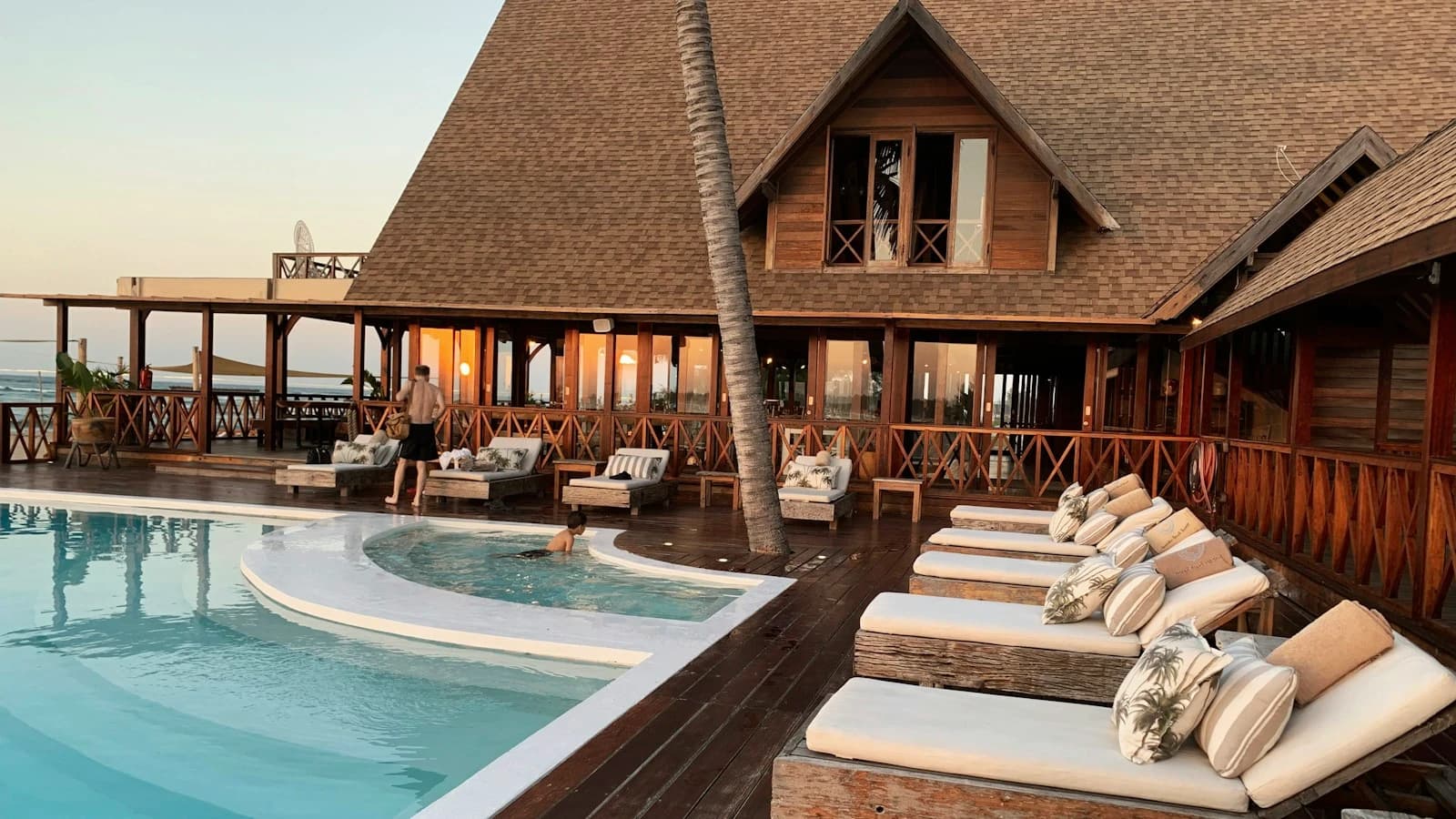 A hotel pool and accommodation setting illustrating guest hospitality.